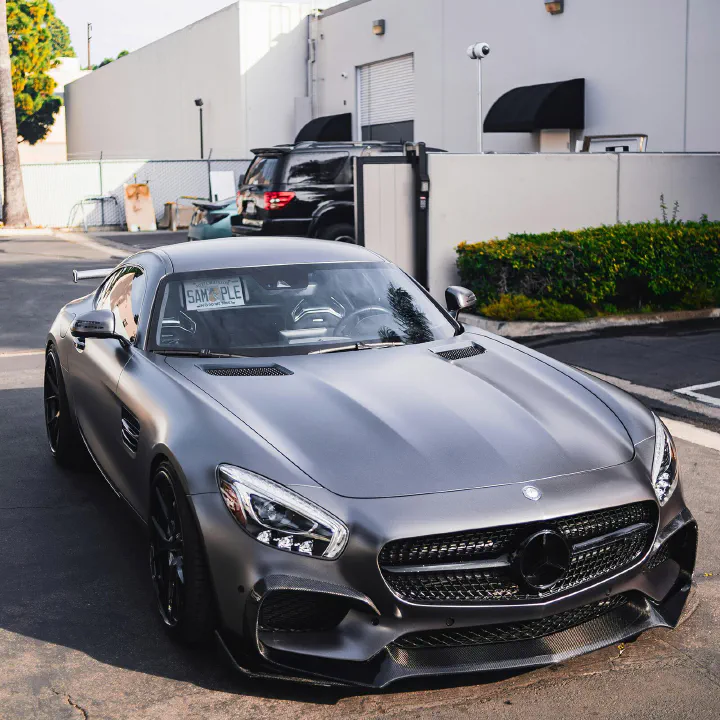 A matte grey Mercedes-AMG GT with a sample plate on the visor.