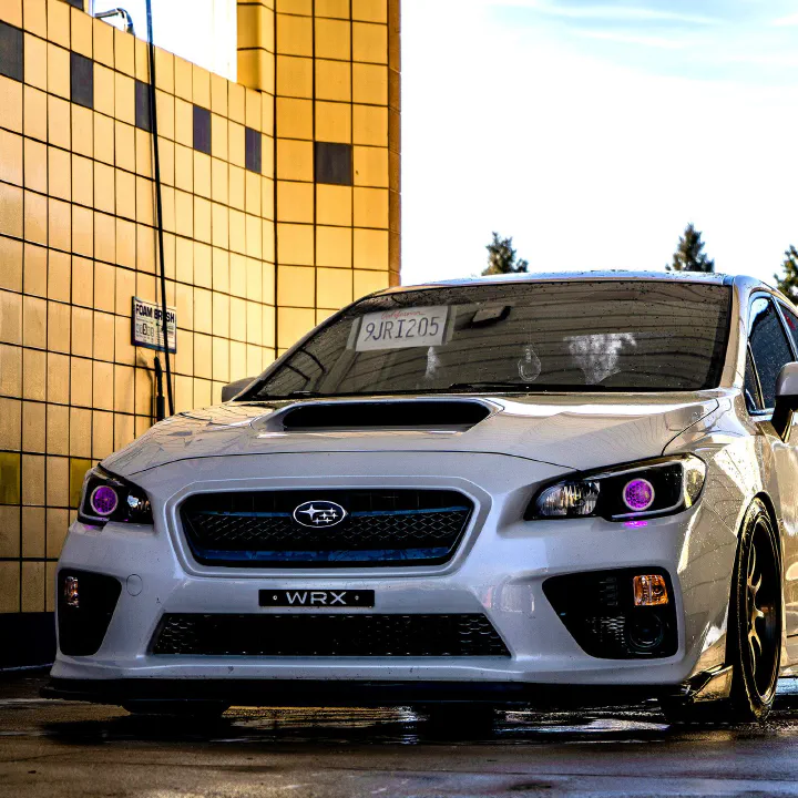 A white Subaru WRX with a plate on the visor.